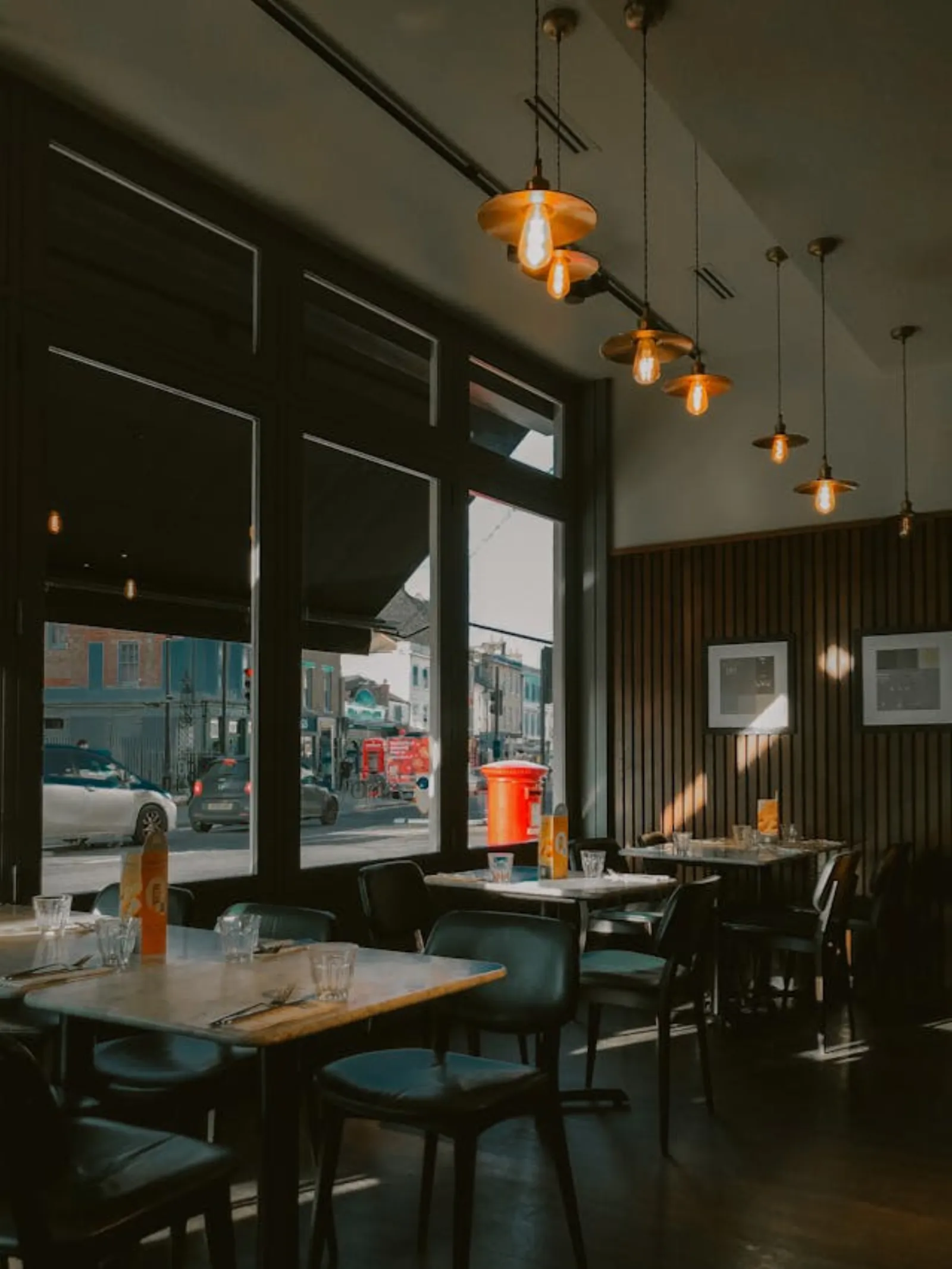 Editorial hospitality interior — restaurant interior with morning light through tall windows